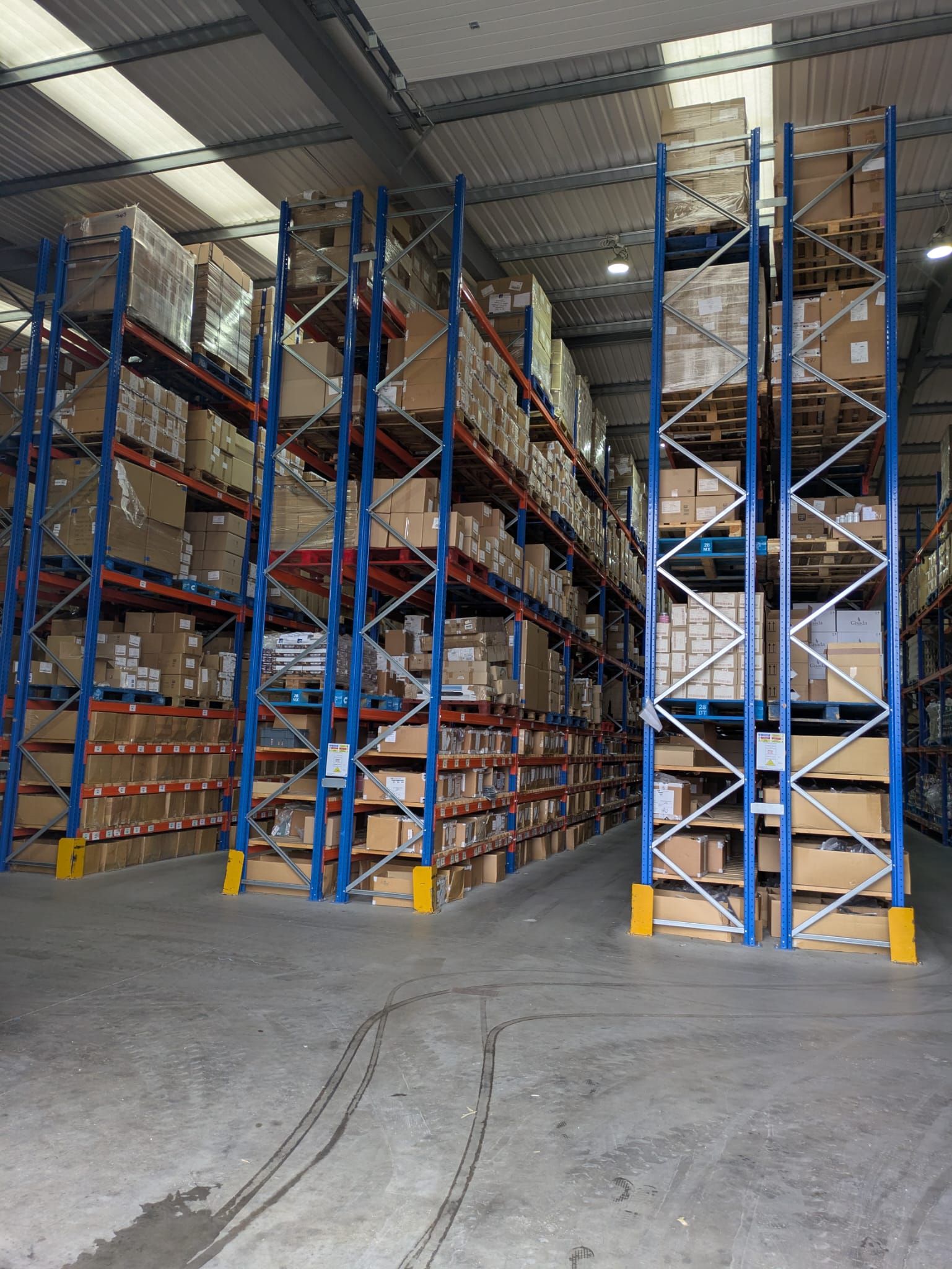 Warehouse interior with high shelves and stacked boxes
