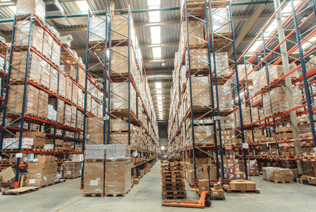 Large warehouse with high shelves filled with cardboard boxes
